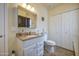 Bright bathroom featuring white cabinets, a large mirror, and utility storage at 7750 E Broadway Rd # 535, Mesa, AZ 85208