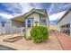 Lovely manufactured home showcasing desert landscaping, stylish siding, and a convenient covered parking area at 7750 E Broadway Rd # 535, Mesa, AZ 85208