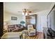 Spacious living room featuring ceiling fan, murphy bed and wood laminate flooring at 7750 E Broadway Rd # 535, Mesa, AZ 85208