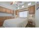 Cozy main bedroom is well lit with a ceiling fan and built in cabinets at 7750 E Broadway Rd # 535, Mesa, AZ 85208
