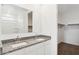 Modern bathroom features double sinks, granite countertop, and a large mirror at 8440 W Clemente Way, Florence, AZ 85132