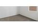 This carpeted bedroom has bright natural light coming in from the window at 8440 W Clemente Way, Florence, AZ 85132