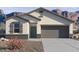 Charming single-story home with gray trim, desert landscaping, and a convenient two-car garage at 8440 W Clemente Way, Florence, AZ 85132