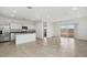 Bright, open-concept room with tile flooring and a view into the adjacent kitchen at 8440 W Clemente Way, Florence, AZ 85132