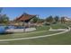 Scenic amphitheater with a covered stage overlooking a tranquil pond and lush greenery at 8519 W Clemente Way, Florence, AZ 85132