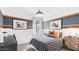 Cozy bedroom with patterned accent wall, striking artwork and soft natural light at 8519 W Clemente Way, Florence, AZ 85132
