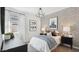 Stylish bedroom featuring patterned wallpaper, modern chandelier, and ample natural light at 8519 W Clemente Way, Florence, AZ 85132