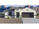 Charming single-story home with a two-car garage and desert landscaping in front at 8519 W Clemente Way, Florence, AZ 85132