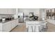 Bright kitchen with white cabinets, granite counters, stainless appliances, and a large island at 8519 W Clemente Way, Florence, AZ 85132