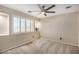 Bedroom with neutral carpet and a bright, shuttered window at 9566 N 83Rd Dr, Peoria, AZ 85345