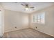 Bedroom featuring neutral carpeting, a ceiling fan, and bright, shuttered windows at 9566 N 83Rd Dr, Peoria, AZ 85345