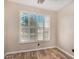 Bedroom featuring wood flooring and bright, shuttered windows at 9566 N 83Rd Dr, Peoria, AZ 85345