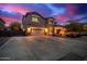 Two-story home with a spacious driveway, well-maintained lawn, and charming front porch at 9566 N 83Rd Dr, Peoria, AZ 85345