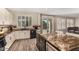 Kitchen with island and seating, stainless steel appliances, granite counters, and tile backsplash at 9566 N 83Rd Dr, Peoria, AZ 85345