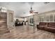 Open living area features hardwood floors, a staircase, and flows into the kitchen at 9566 N 83Rd Dr, Peoria, AZ 85345