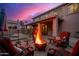 Outdoor seating area with a cozy fire pit, ideal for entertaining and enjoying the backyard view at 9566 N 83Rd Dr, Peoria, AZ 85345