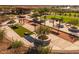 Community common area with covered seating, lush landscaping, bocce ball and walking paths at 980 W Ridge Rd, Apache Junction, AZ 85120