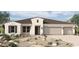 Beautiful single-story home with neutral stucco, three-car garage, desert landscaping and brown roof in Arizona at 980 W Ridge Rd, Apache Junction, AZ 85120