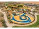 Aerial view of the playground with colorful equipment, walking paths, and safety surfaces at 980 W Ridge Rd, Apache Junction, AZ 85120
