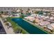 Aerial view of residential area with private homes lining a scenic community pond at 10387 W Runion Dr, Peoria, AZ 85382