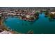 Aerial view featuring homes along the lake with private patios, lush landscaping and mature palm trees in a lakeside community at 10387 W Runion Dr, Peoria, AZ 85382