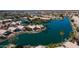 Aerial view featuring home with lake access, private dock, lush landscaping and mature trees in a well maintained community at 10387 W Runion Dr, Peoria, AZ 85382
