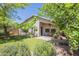 Charming home featuring a well-maintained backyard with mature trees and patio at 10387 W Runion Dr, Peoria, AZ 85382