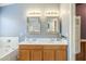 Bathroom featuring double sinks, tub, vanity and framed mirrors at 10387 W Runion Dr, Peoria, AZ 85382