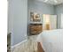 Light-filled bedroom with ensuite bathroom, wood floors, and a spacious closet at 10387 W Runion Dr, Peoria, AZ 85382