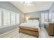 Bright bedroom with high ceilings, wood floors, and large windows with plantation shutters at 10387 W Runion Dr, Peoria, AZ 85382