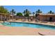 Inviting community pool with ample seating, shaded areas, and desert landscaping at 10387 W Runion Dr, Peoria, AZ 85382