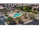Aerial view of community pool and spa with shaded seating and lush landscaping at 10387 W Runion Dr, Peoria, AZ 85382
