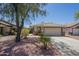 Charming single-story home features a well-maintained landscape, a tiled roof and a two-car garage at 10387 W Runion Dr, Peoria, AZ 85382