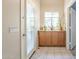 Welcoming foyer featuring tile floors, neutral walls, and a storage cabinet with a window at 10387 W Runion Dr, Peoria, AZ 85382
