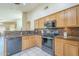 Well-appointed kitchen with stainless steel appliances, tiled backsplash, and wooden cabinetry at 10387 W Runion Dr, Peoria, AZ 85382