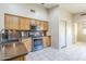Modern kitchen featuring stainless steel appliances, tile backsplash, and tile flooring at 10387 W Runion Dr, Peoria, AZ 85382