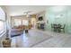 Spacious living room with tile flooring, a ceiling fan, and fireplace with stone hearth and decorative mantle at 10387 W Runion Dr, Peoria, AZ 85382