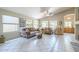 Bright, open living room featuring tile floors, large windows, vaulted ceilings and comfortable seating at 10387 W Runion Dr, Peoria, AZ 85382