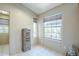 Bright office space with natural light, featuring tiled floors and a decorative wooden storage unit at 10387 W Runion Dr, Peoria, AZ 85382