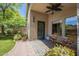 Covered patio area with brick pavers, desert landscaping, ceiling fan and chairs at 10387 W Runion Dr, Peoria, AZ 85382