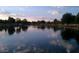 Scenic view of the lake with clear water reflecting the sky, trees, and surrounding community at 10387 W Runion Dr, Peoria, AZ 85382