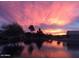 Beautiful sunset colors reflect off the serene waters of the community pond at 10387 W Runion Dr, Peoria, AZ 85382