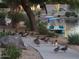 Scenic view of a pond with ducks on the shore, a pedal boat on the water, and lush landscaping at 10387 W Runion Dr, Peoria, AZ 85382