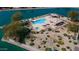 Aerial view of community pool, spa, and clubhouse in a well maintained park-like setting along the lake at 10387 W Runion Dr, Peoria, AZ 85382