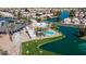 Aerial view featuring community pool and park-like area with walkways and benches along the lake at 10387 W Runion Dr, Peoria, AZ 85382
