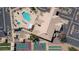Aerial view showing pool, clubhouse, tennis court, shuffle board and other recreation area surrounded by parking lot at 10387 W Runion Dr, Peoria, AZ 85382