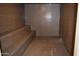 This modern sauna offers sleek tile walls, seating, and a drainage system for a luxurious experience at 10387 W Runion Dr, Peoria, AZ 85382