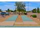 Community shuffleboard courts alongside parking area for recreational fun at 10387 W Runion Dr, Peoria, AZ 85382