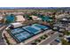 Aerial view of community tennis and pickle ball courts surrounded by lush landscaping and nearby parking at 10387 W Runion Dr, Peoria, AZ 85382
