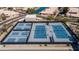 Aerial view of multiple tennis courts with well-maintained surfaces and surrounding landscaping in the community at 10387 W Runion Dr, Peoria, AZ 85382